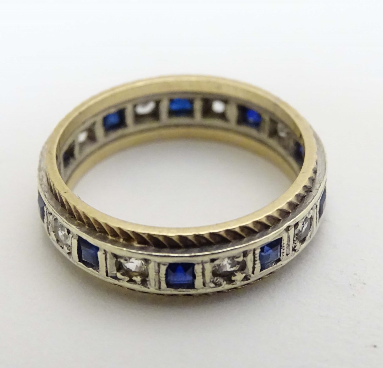 A 9ct gold ring set with blue and white stones.