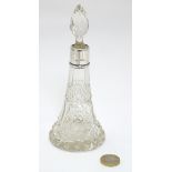 A cut glass scent / perfume bottle with silver collar hallmarked London 1911 maker Hart & Sons.
