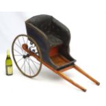 A Victorian Dog Cart with upholstered button back leather seat, hand painted wooden shafts,