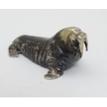 A white metal model of a walrus.