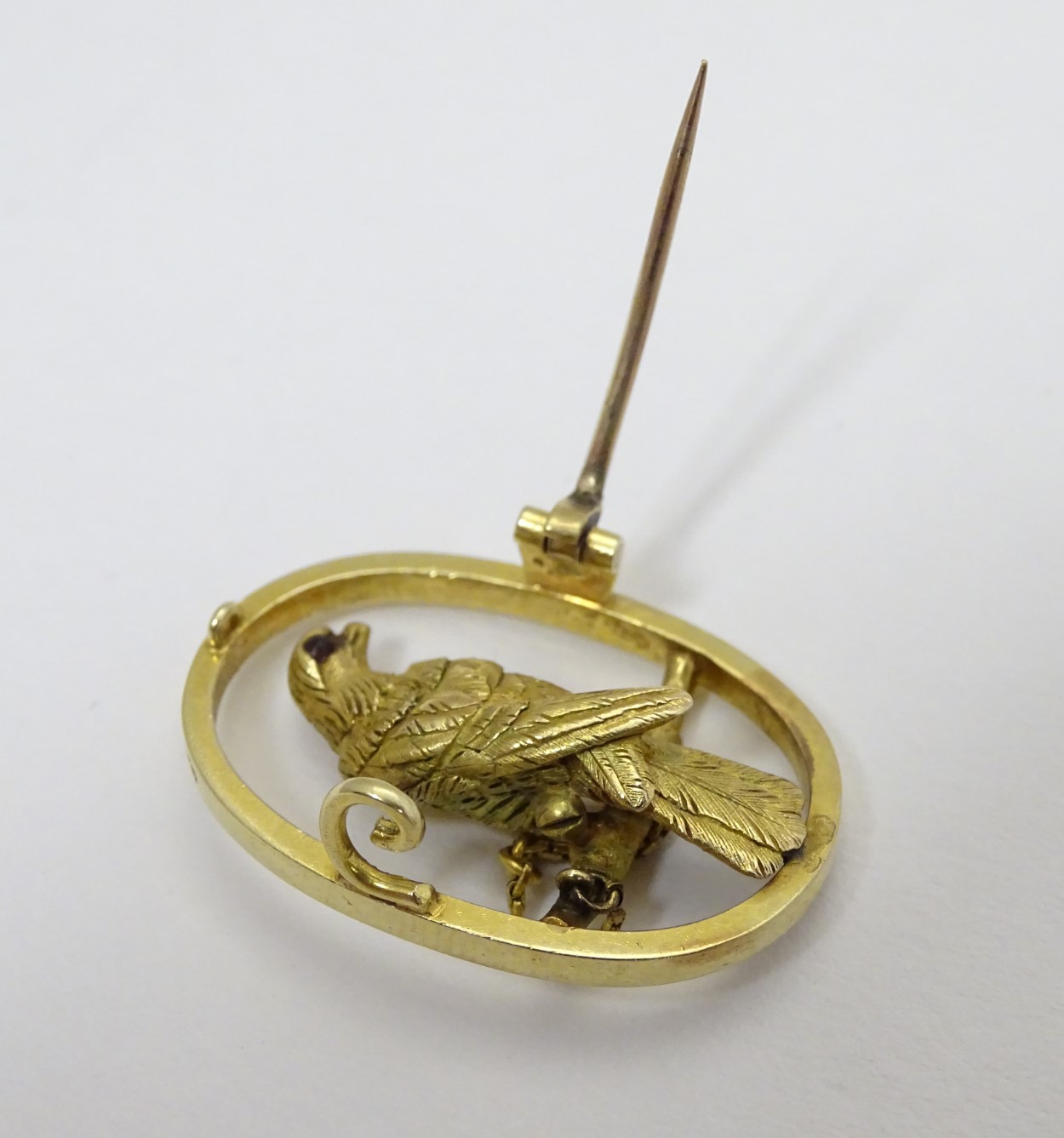 A 15ct gold brooch of oval form with falcon bird to centre 1 1/4" high CONDITION: - Image 3 of 5