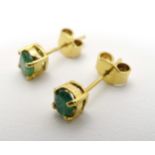 A pair of 9ct gold earrings set with emerald green stones CONDITION: Please Note -