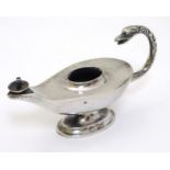 A silver table lighter / cigar lighter in the form of a Roman lamp .