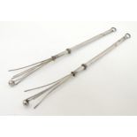 A pair of silver plate retractable swizzle sticks 6 1/2" long ( extended) (2) CONDITION: