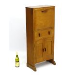 Arts & Crafts - A walnut students desk with fall front containing pigeon holes and small drawers,