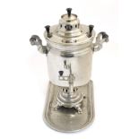 A c,.1900 nickel plate samovar and stand.