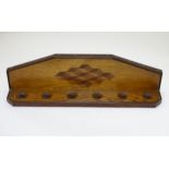 Pipe smoking: An early 20thC oak pipe rack, with provision for six pipes,