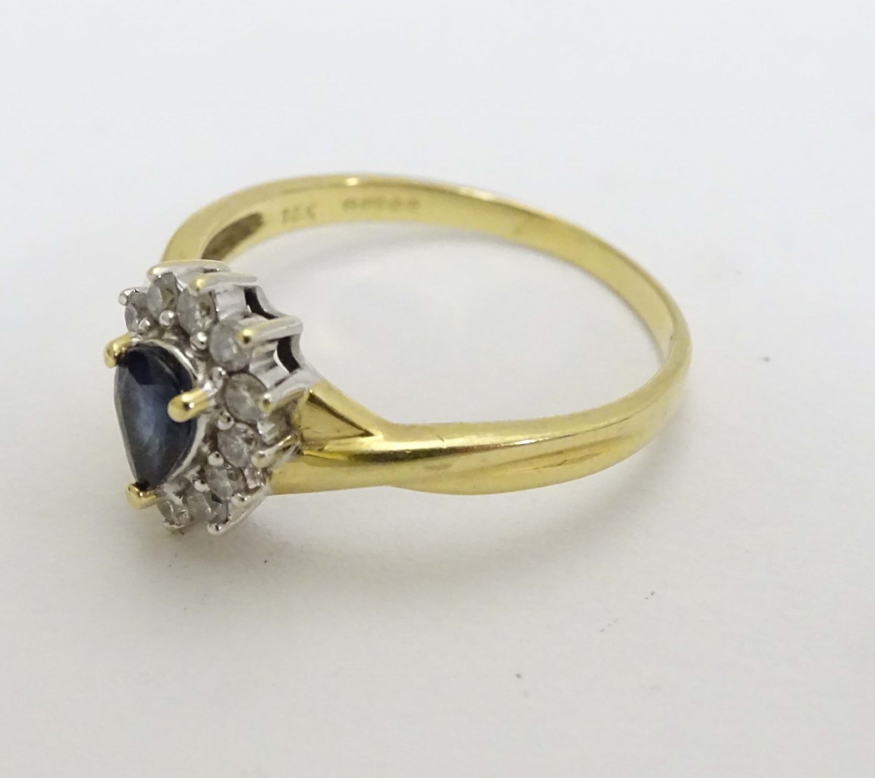 An 18ct gold ring set with central blue stone bordered by diamonds CONDITION: - Image 4 of 6