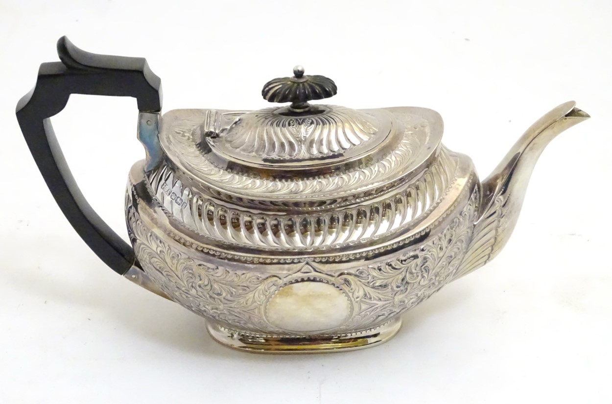 A silver teapot hallmarked Sheffield 1899 maker Atkin Brothers with acanthus scroll decoration 6"