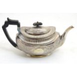 A silver teapot hallmarked Sheffield 1899 maker Atkin Brothers with acanthus scroll decoration 6"