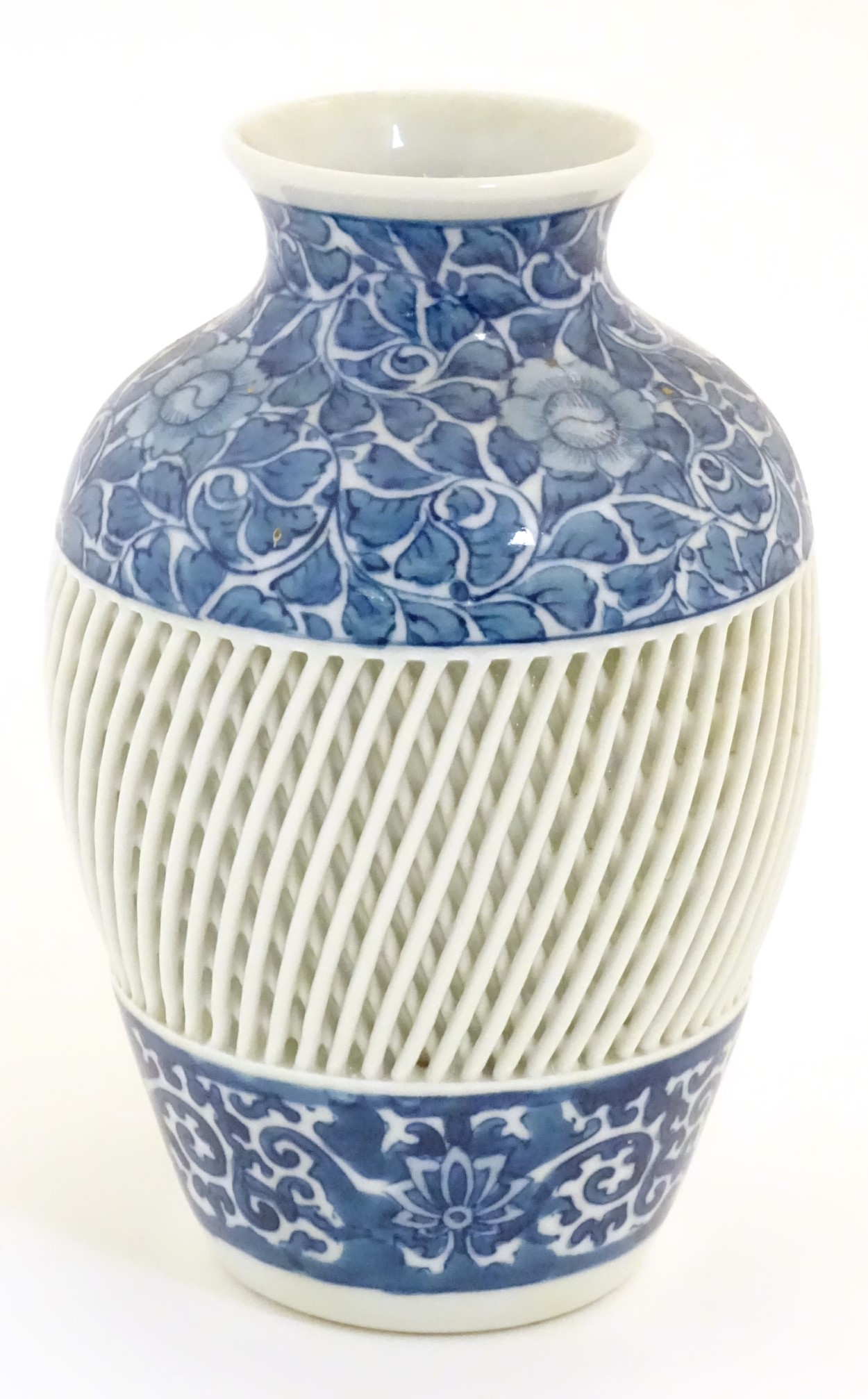 A blue and white Chinese baluster vase decorated with a floral pattern and a reticulated banded