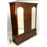 A late 19thC / early 20thC mahogany wardrobe with ogee cornice above moulded frieze with two