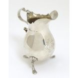 A silver cream jug,