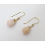 A matched pair of rose quartz facet cut drop earrings .