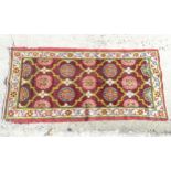 Rug / carpet : A circa 1900 hand made Arts and Crafts rug with 7 full central floral motifs and
