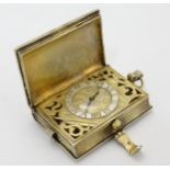 A hallmarked Silver pendant Book watch : A silver pendant watch formed as a book with clasp,