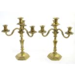 A pair of 19thC ornate three branch candelabra on hexagonal bases with ornate triform bases.