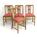 A set of four early / mid 20thC Ercol dining chairs with pierced back splat and standing on squared