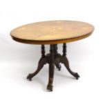 A late 19thC walnut loo table with an oval tilt top inlaid with floral decoration and decorative