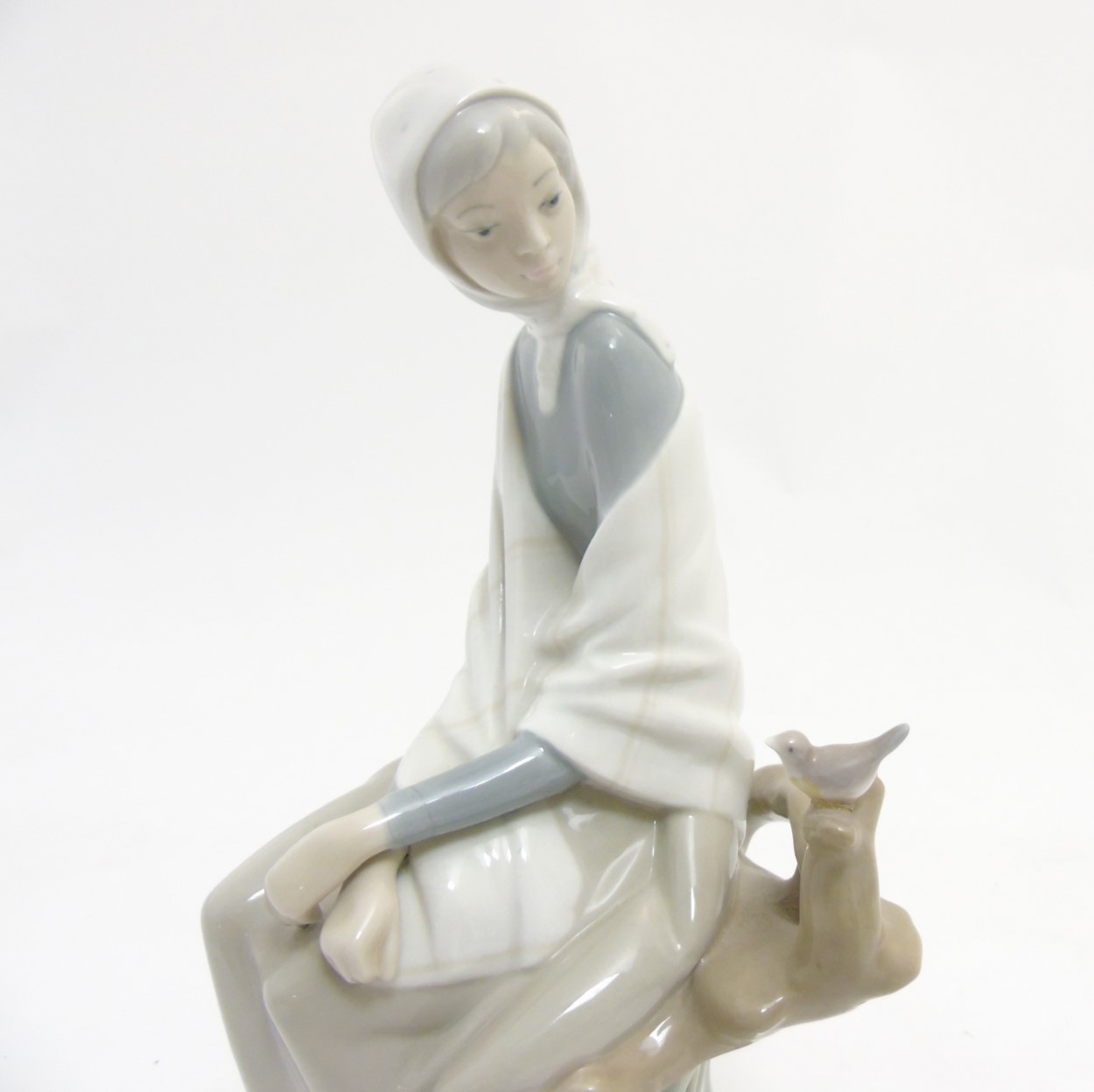 A Lladro 'New Shepherdess' figurine of a girl sat watching a bird, makers mark to base, - Image 7 of 8