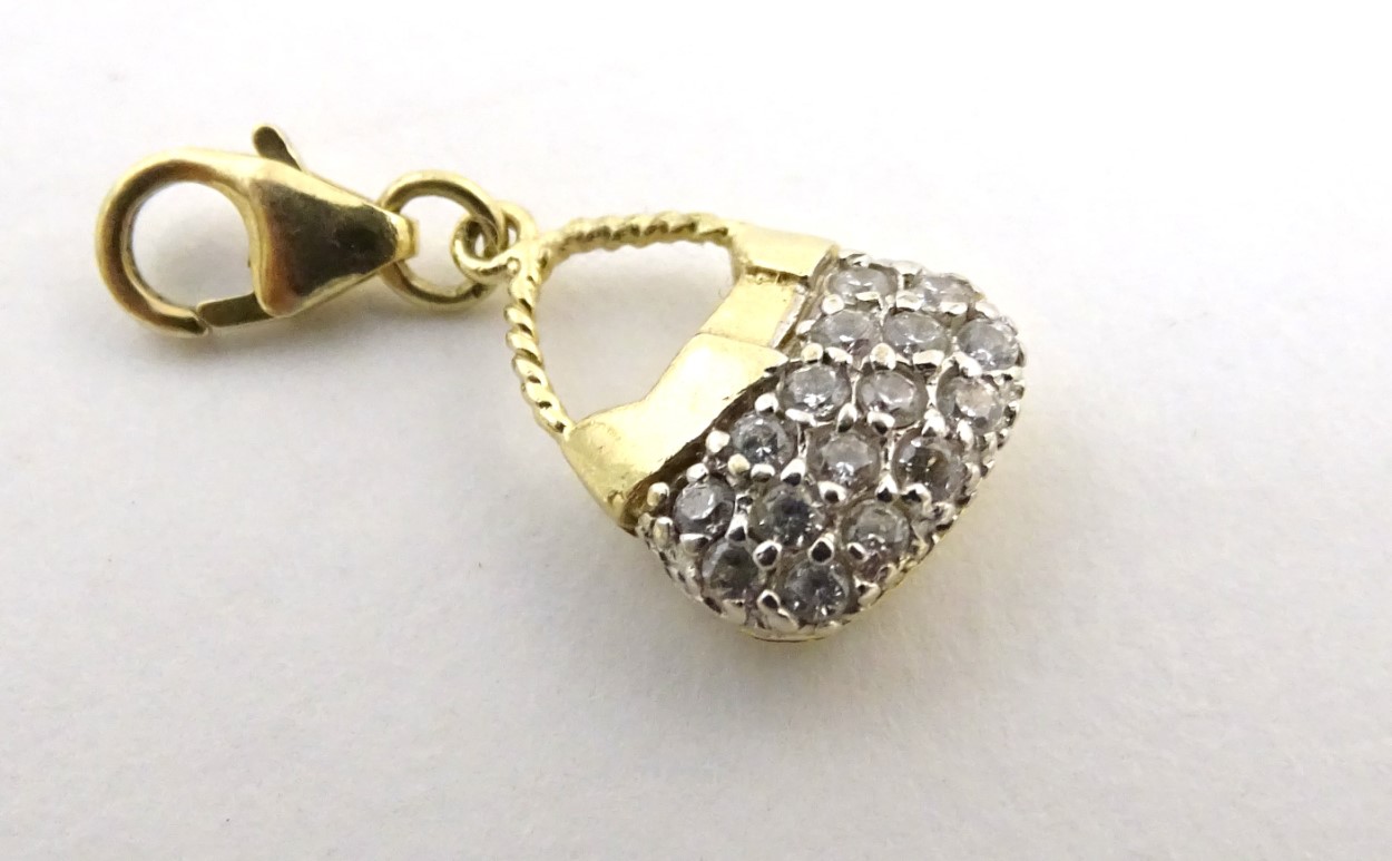 A 14ct gold pendant / fob formed as a basket set with white stones.