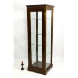 A mid / late 20thC oak display cabinet with single large door,
