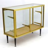 Vintage Retro : a 1950's brass shop counter with glazed adjustable height shelves and square