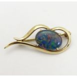 A 9ct gold brooch set with opal cabochon 1 3/8" long CONDITION: Please Note - we do