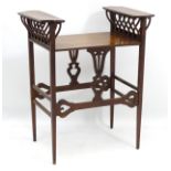 An unusual Arts and Crafts occasional table with two raised galleries and ribbed supports on either