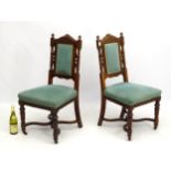 A pair of early 20thC chairs with carved cresting rail and adorned with gadrooned finials,