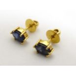 Yellow metal stud earrings set with facet cut blue stones CONDITION: Please Note -
