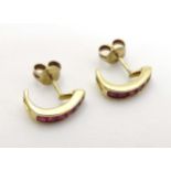A pair of 9ct gold earrings set with red stones CONDITION: Please Note - we do not