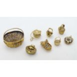 A collection of assorted gold and gilt metal basket formed pendant charms and miniature baskets,