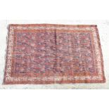 Rug / carpet : a Persian hand made old rug having a red rust ground (plus navy blue to centre) with