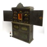 An 18thC Japanned lacquered cabinet with shaped pediment and applied point,