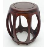 A mid / late 20thC Chinese bow sided cylindrical mahogany stool.