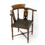 An early 20thC corner chair with marquetry inlay to the back supports,