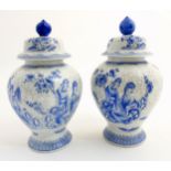 A pair of Maitland Smith blue and white Oriental lidded vases with craquelure style decoration,