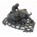 Chinese : A carved recumbent water buffalo with a boy seated on his back, in dark hardwood ,