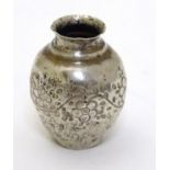 A Continental white metal miniature vase with floral decoration.