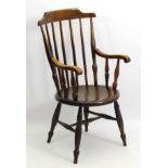A late 19thC / early 20thC oak and beech ibex style spindle back Windsor chair,