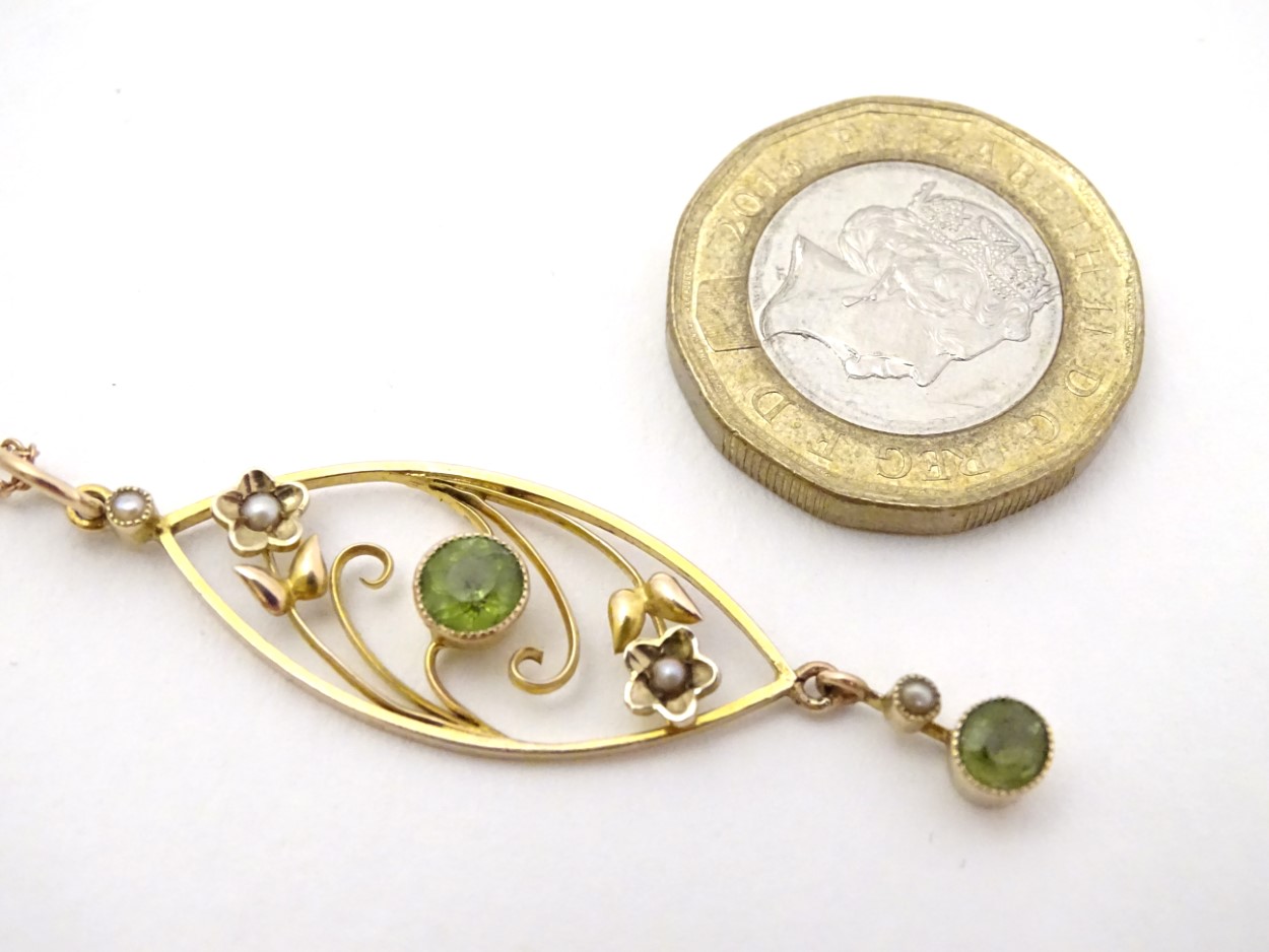 A yellow metal pendant and chain, the pendant set with peridot and seed pearls. - Image 3 of 4