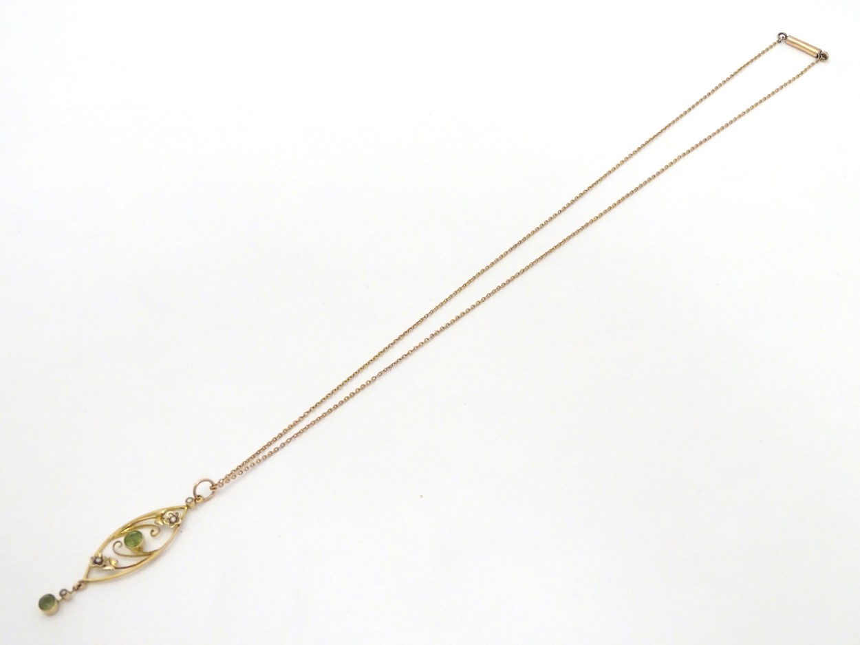 A yellow metal pendant and chain, the pendant set with peridot and seed pearls. - Image 4 of 4
