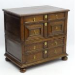 A William and Mary oak chest of drawers comprising four long drawers with geometric moulding to the