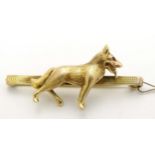 A 9ct gold bar brooch set with model of an Alsatian type dog to centre with ruby eyes . Maker M&M.
