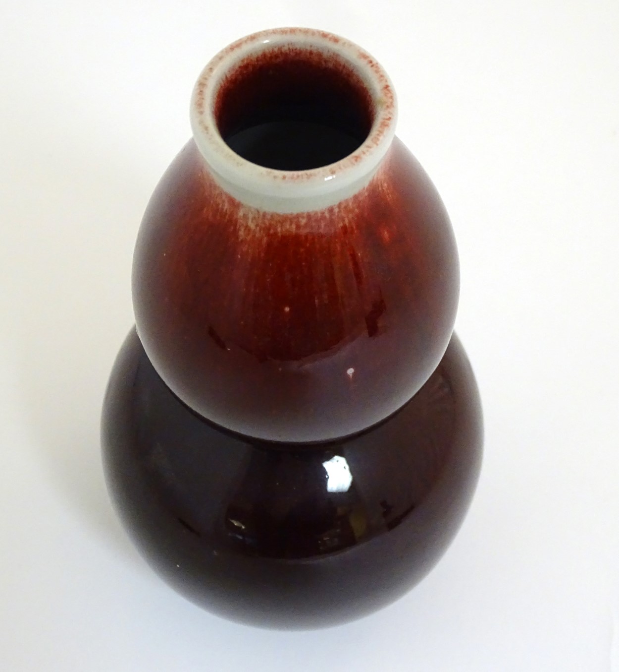 A Chinese sang-de-boeuf double gourd, high fired porcelain vase. Indistinct Chinese marking to base. - Image 10 of 10