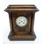 19 th C oak cased Mantle Clock : an ornate carved column sided mantle clock with 8 day Japy Frere