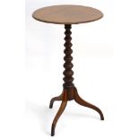 A late 19thC mahogany tripod table with turned tapering pedestal base and standing on three splayed