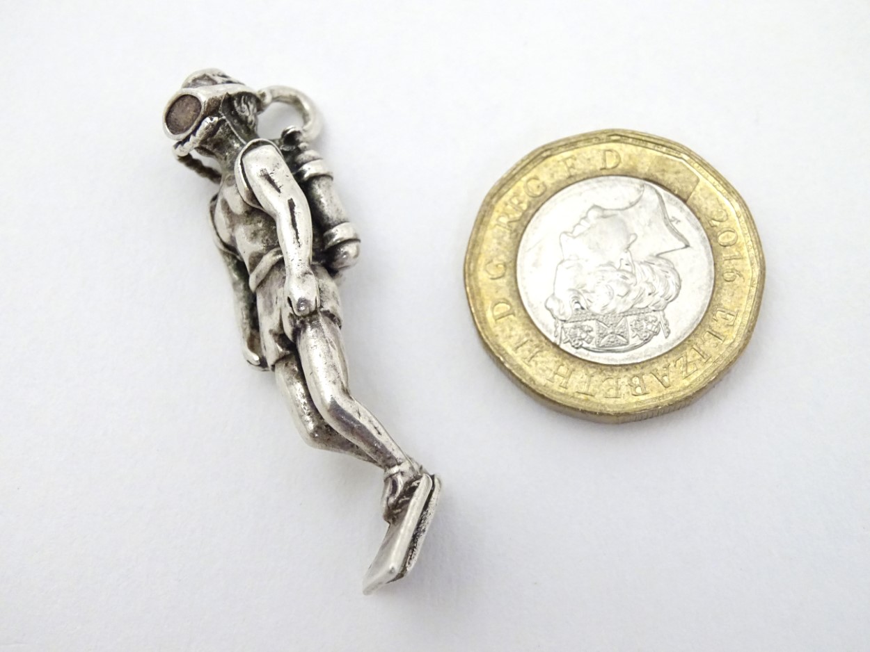 A Mexican silver pendant formed as a model of a scuba diver . Marked under.