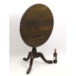 A mid 18thC oak tilt top tripod table,